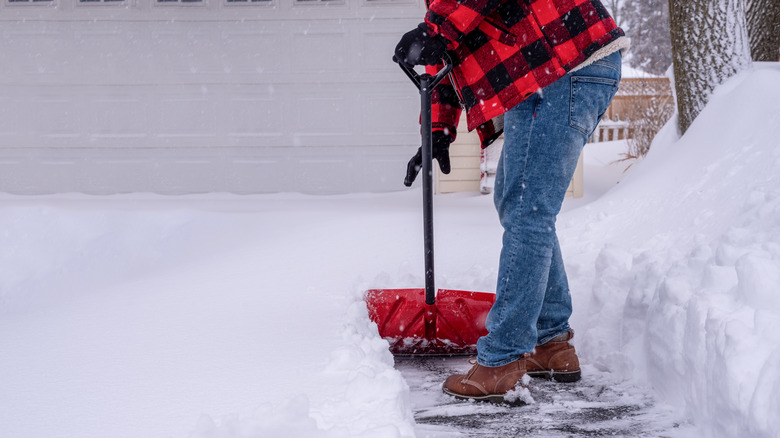 Person shoveling snow from a driveway