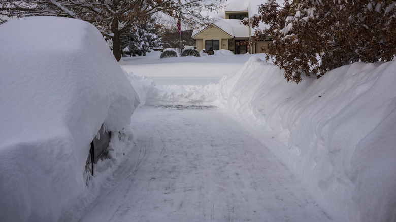 Snow covered car and driveway