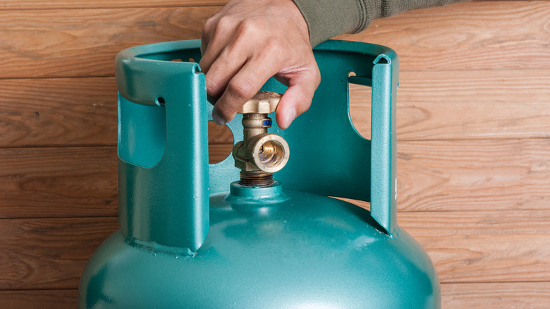 Person turning off propane tank