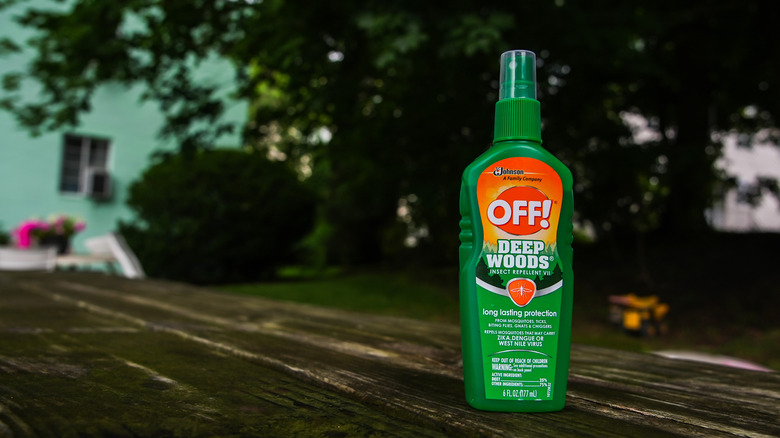 Green bottle of OFF! brand insect repellent on an outdoor table