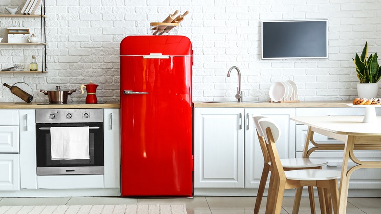 White kitchen with red fridge