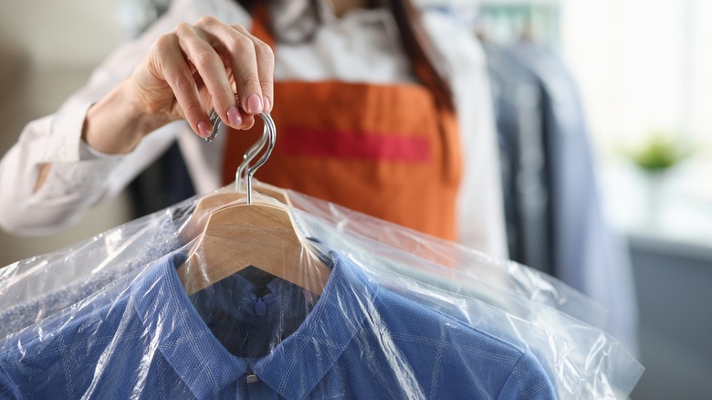 handing over dry-cleaned clothes