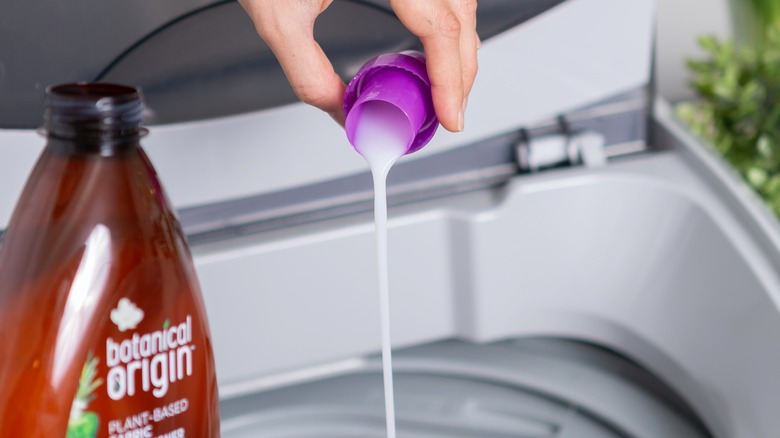 Detergent being poured in washer 