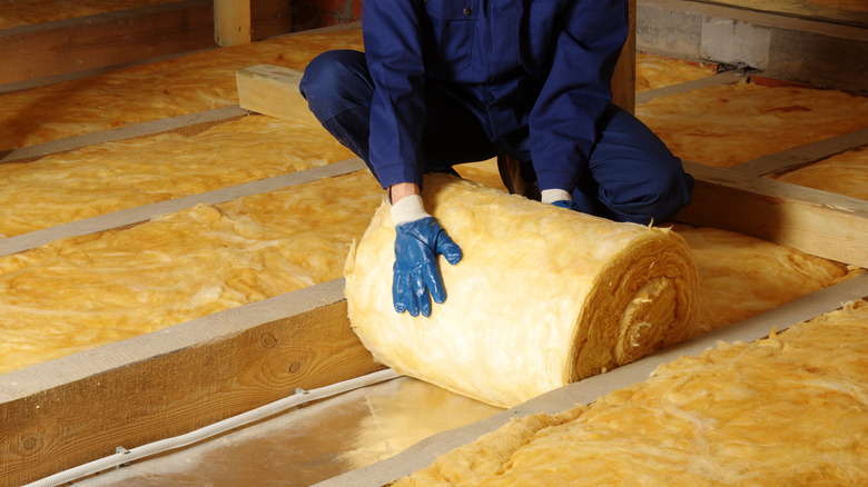 Person installing insulation