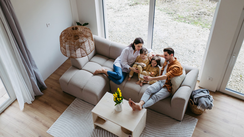 family sitting in living room in a minimalist home
