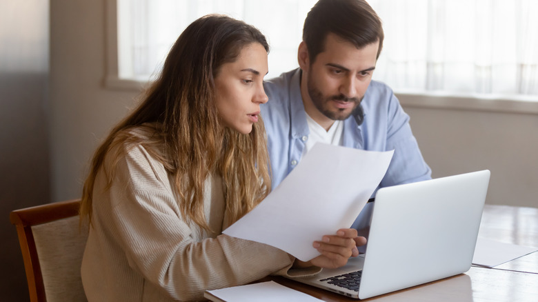 Young couple reviewing a mortgage agreement