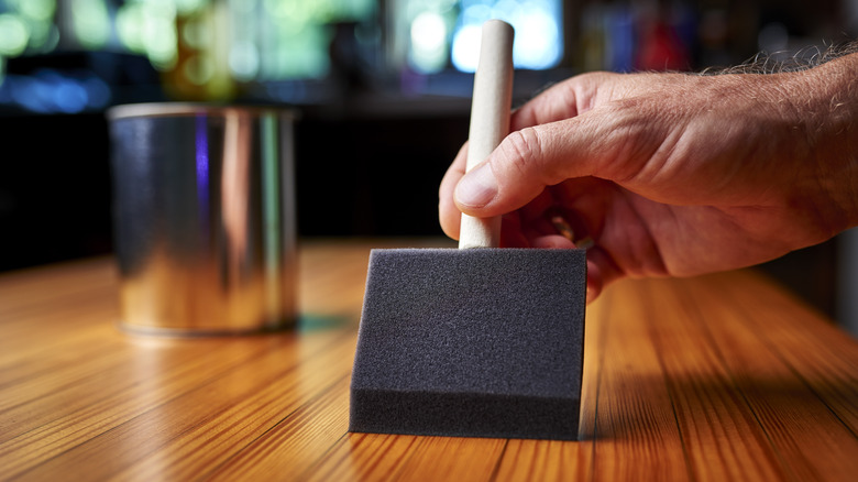 man applying sanding sealer