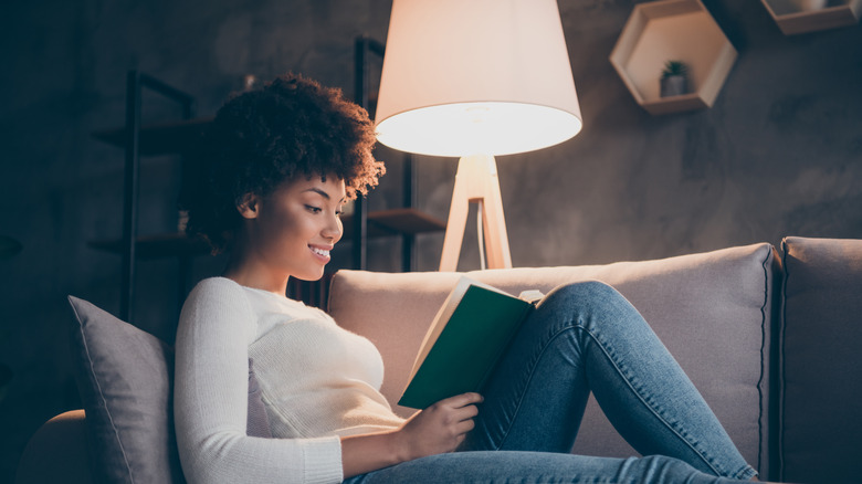 Person beside a reading lamp