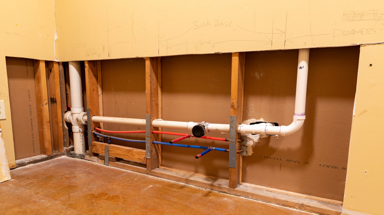 A wall opened up to add new plumbing