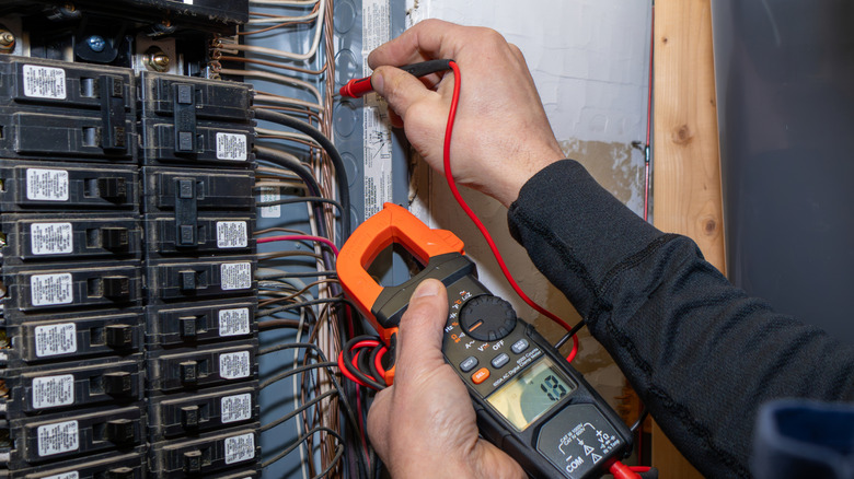 An electrician checking circuit breakers