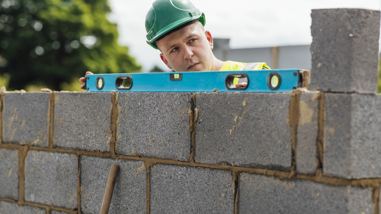 a level is used to construct a cinder block wall