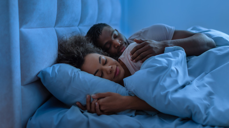 Couple sleeping on a mattress