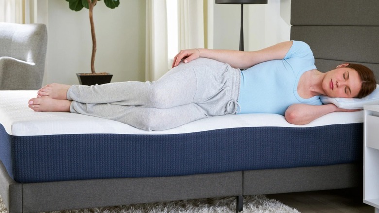 Woman laying on her side on a Costco mattress