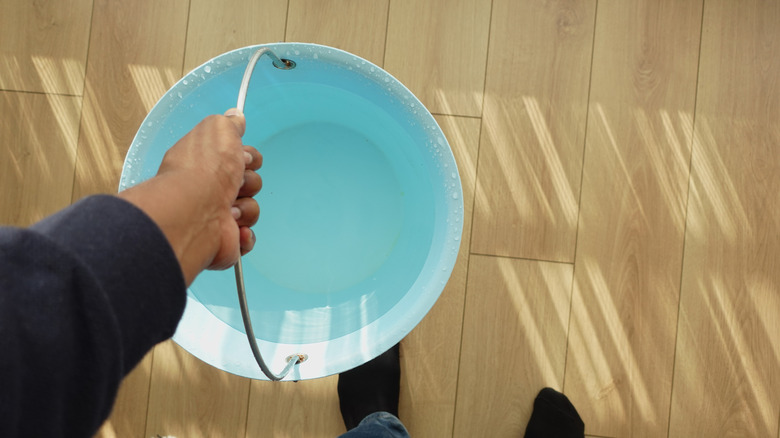 A person carrying a bucket of water