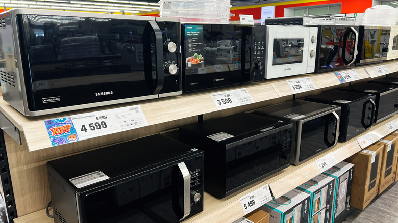 Microwaves on a shelf in a store