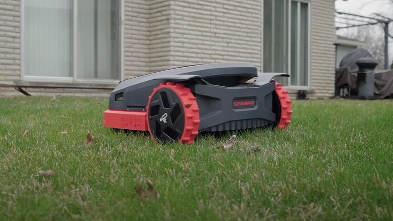 The Segway X350N robot lawn mower in a grass yard