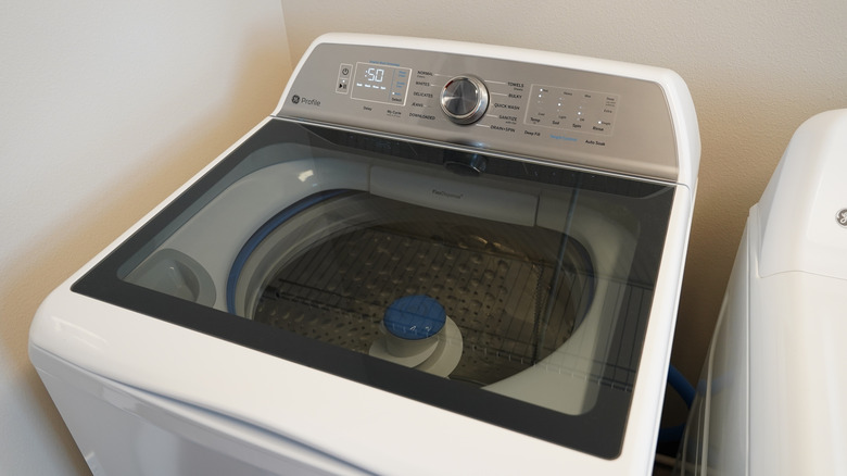 Top-load GE washing machine in laundry room