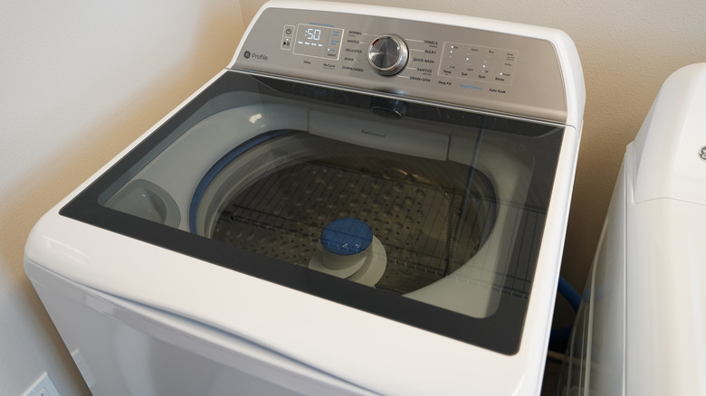 Top-load GE washing machine in laundry room