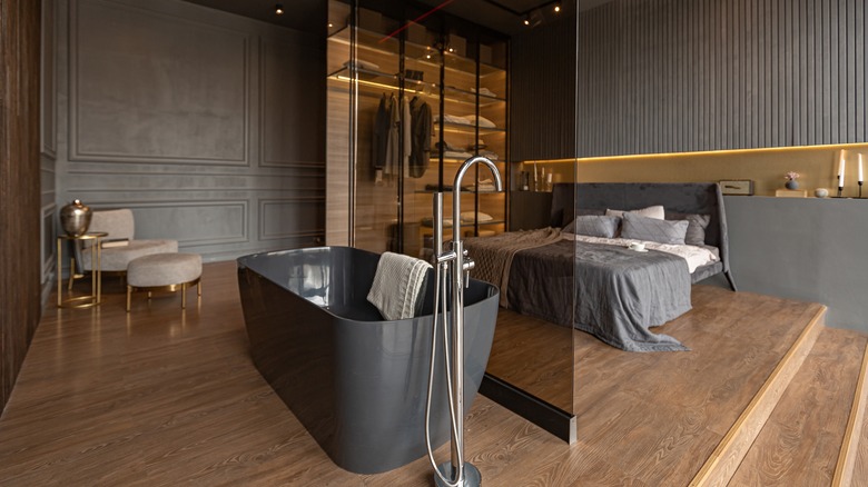 bedroom with glass bathroom partition