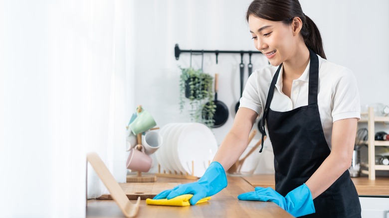 woman cleaning kitchen