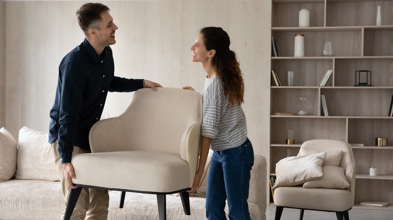 couple carrying chair