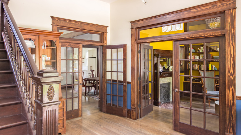 Glass transom windows over glass doors inside old home