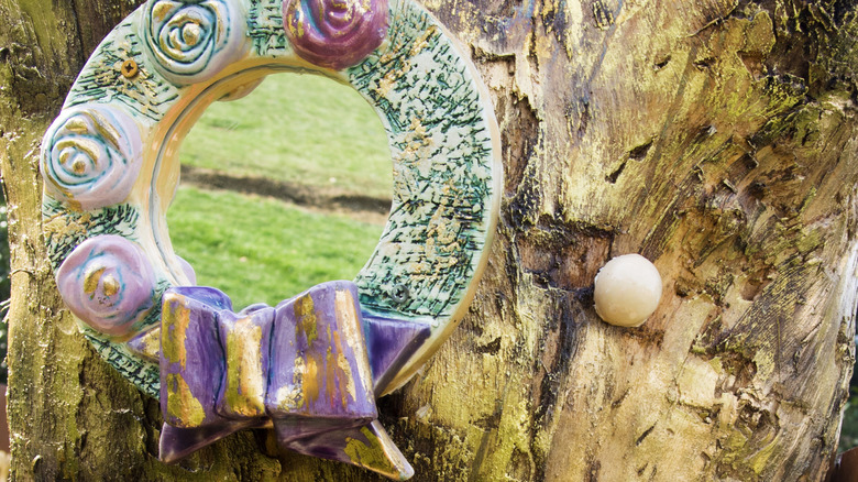 colorful mirror hanging from tree