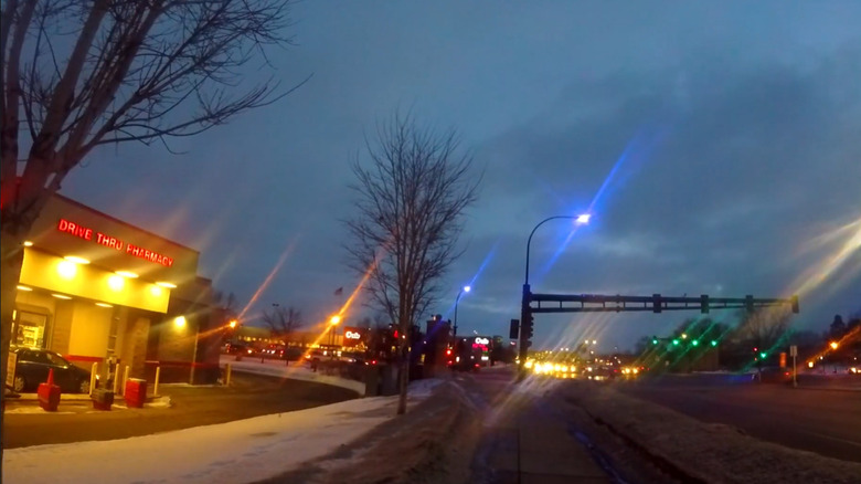 Streetlamps over a major street emitting a bluish-purple glow