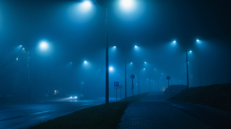 Street lamps on a street emitting an ultraviolet/ blue light