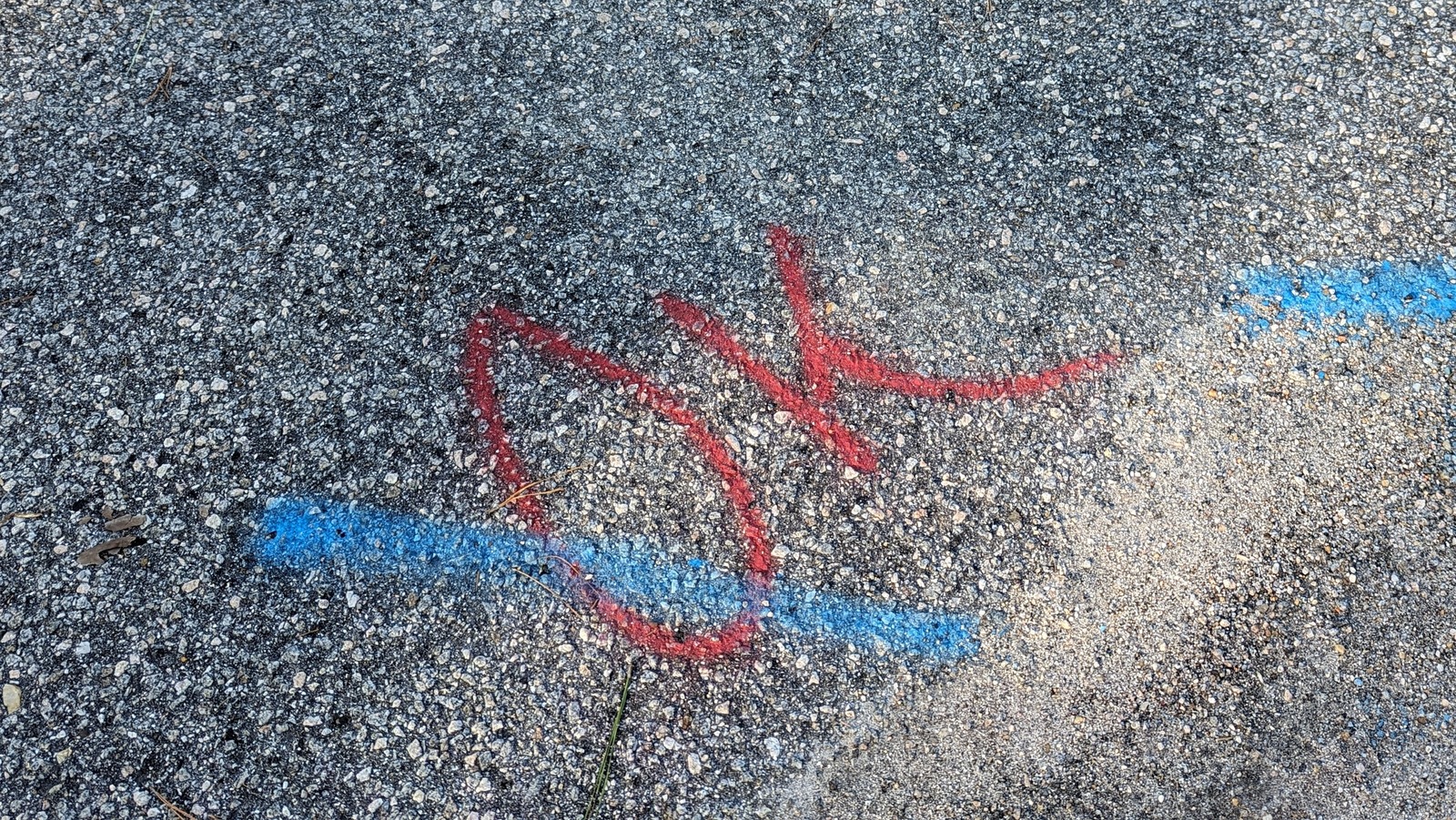 What It Means If You See Red Markings On The Pavement Outside Of