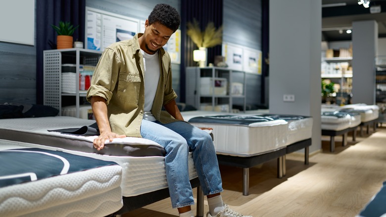man shopping for new mattress
