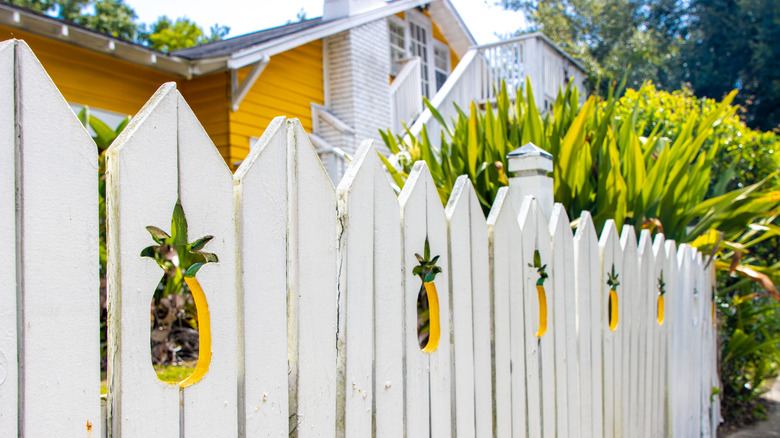 Pineapple decoration on white fence