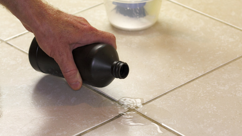 Pouring hydrogen peroxide on tile floor