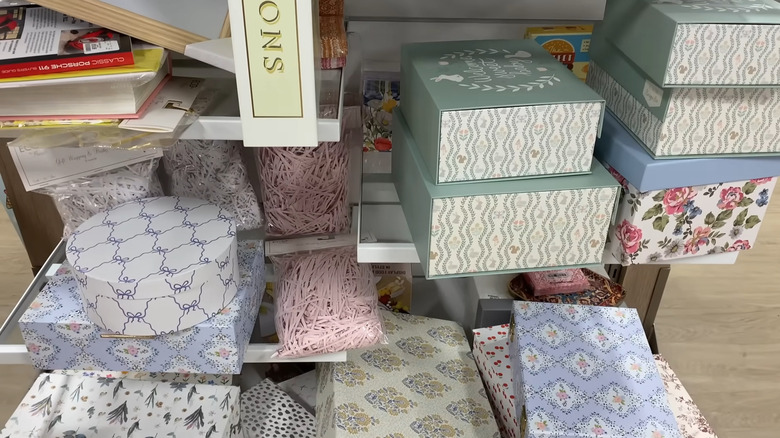 Decorative boxes on a shelf at HomeGoods