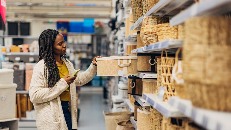 A person shopping for baskets at a home decor store