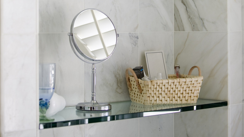 Floating glass shelf in a bathroom.