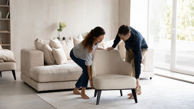 Couple moving armchair