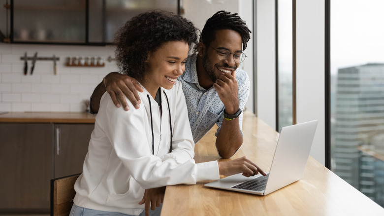 Couple using laptop