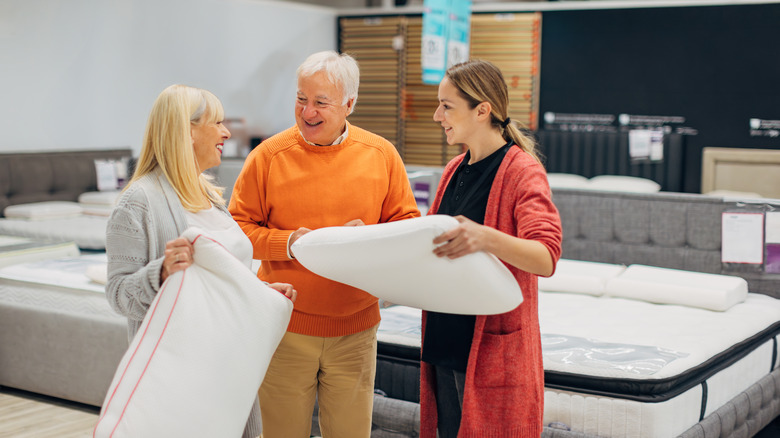 Couple considering pillows at store
