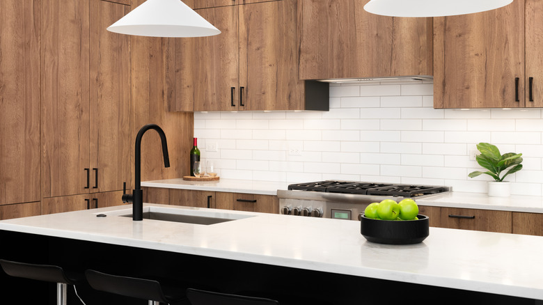 quartz countertops in a modern kitchen with a black island