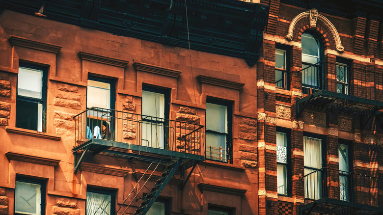 Top floors of a brownstone building in an urban setting.