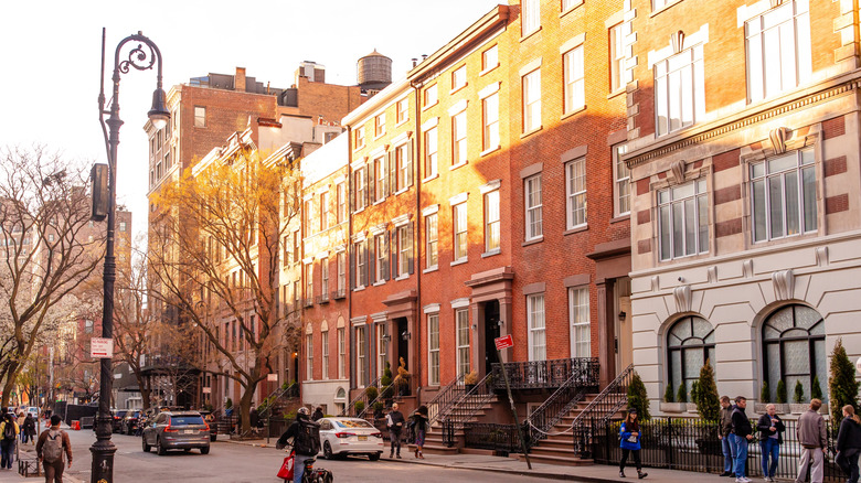 A charming street scene in Greenwich Village, Manhattan, New York City, classic brownstone buildings, popular for strolling and exploring its unique shops