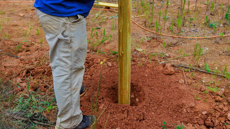 Fitting a wood fence post in a hole