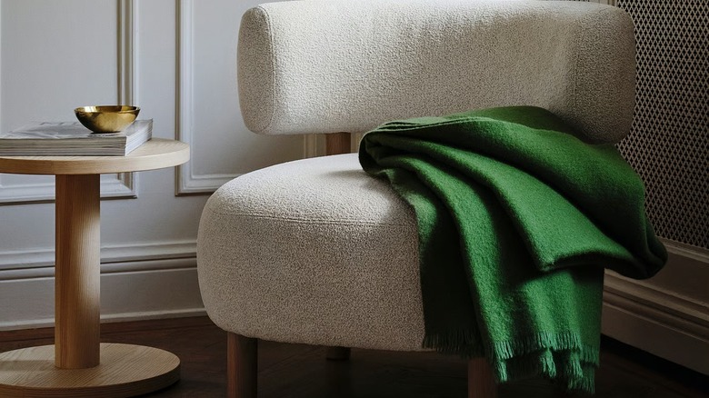 IKEA boucle chair with a green cloth on it