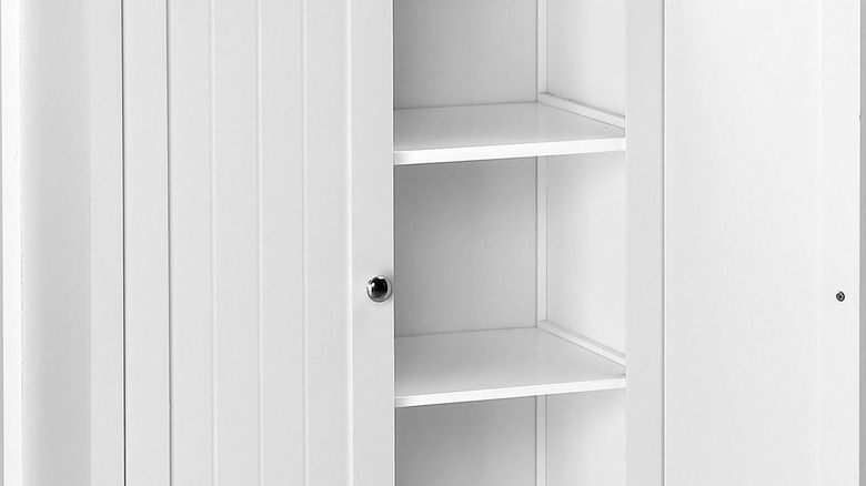 A close up of the interior of the white bathroom cabinet