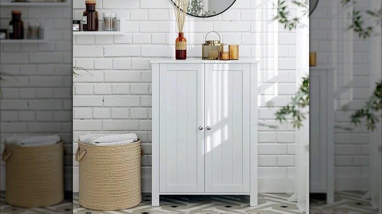 A white Ktaxon cabinet in a minimalistic bathroom.