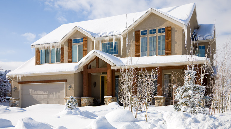 House with snowy driveway