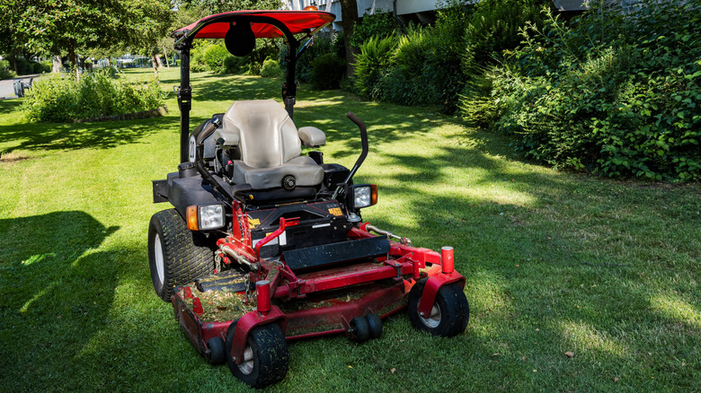 A zero turn riding mower with a large cutting deck