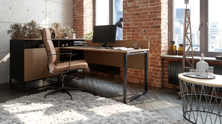 A corner home office set up in a living room of a house