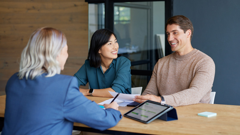 A young couple meeting with their financial advisor